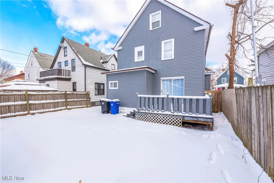 Snow covered property featuring a deck