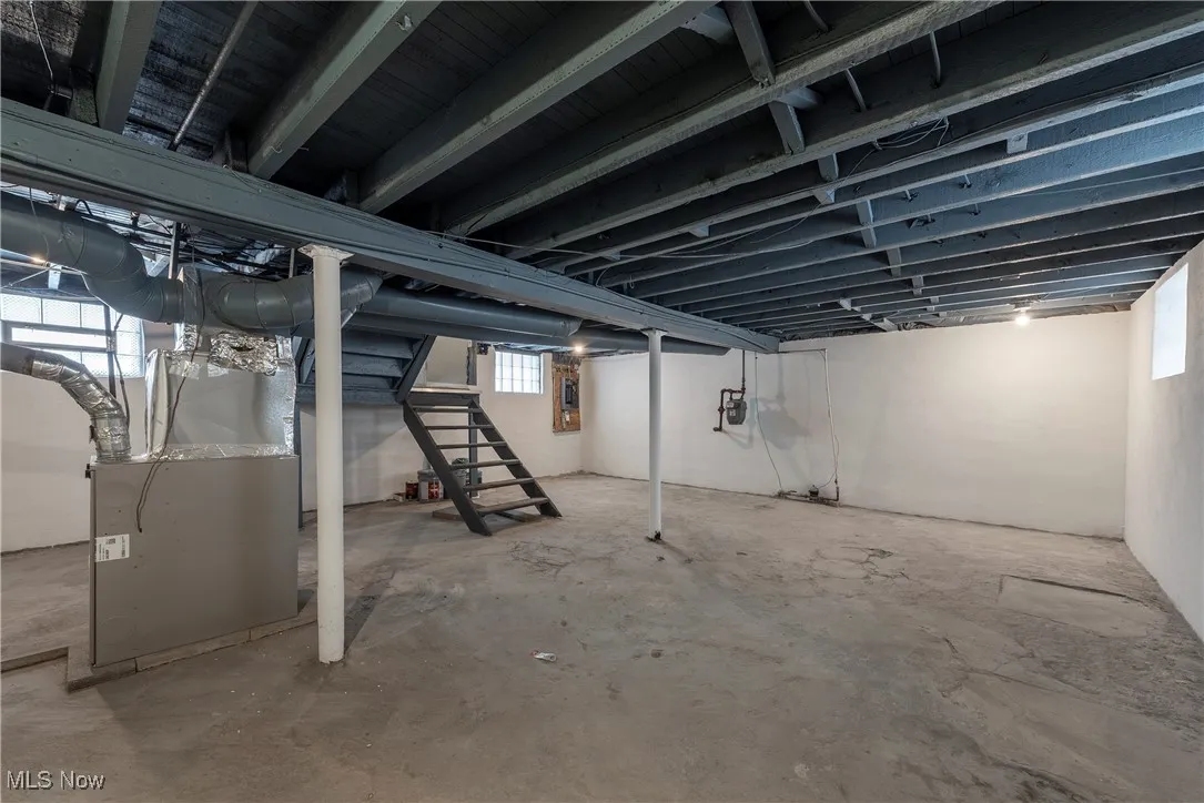 Basement featuring heating unit