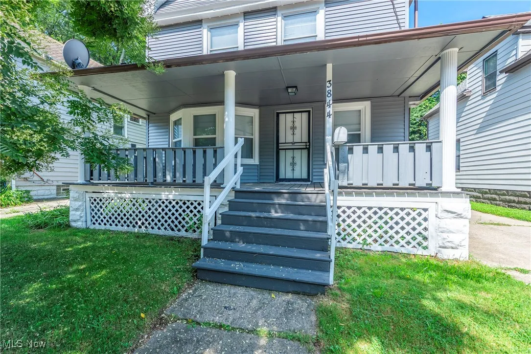 View of front of property featuring covered porch and a front yard