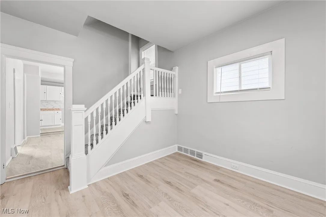 Stairway with hardwood / wood-style floors