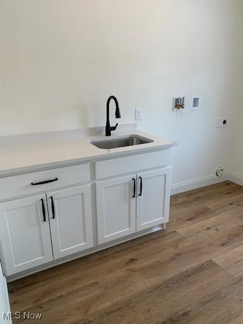 abundant laundry room with vanity, quartz counter top, closet and exterior door