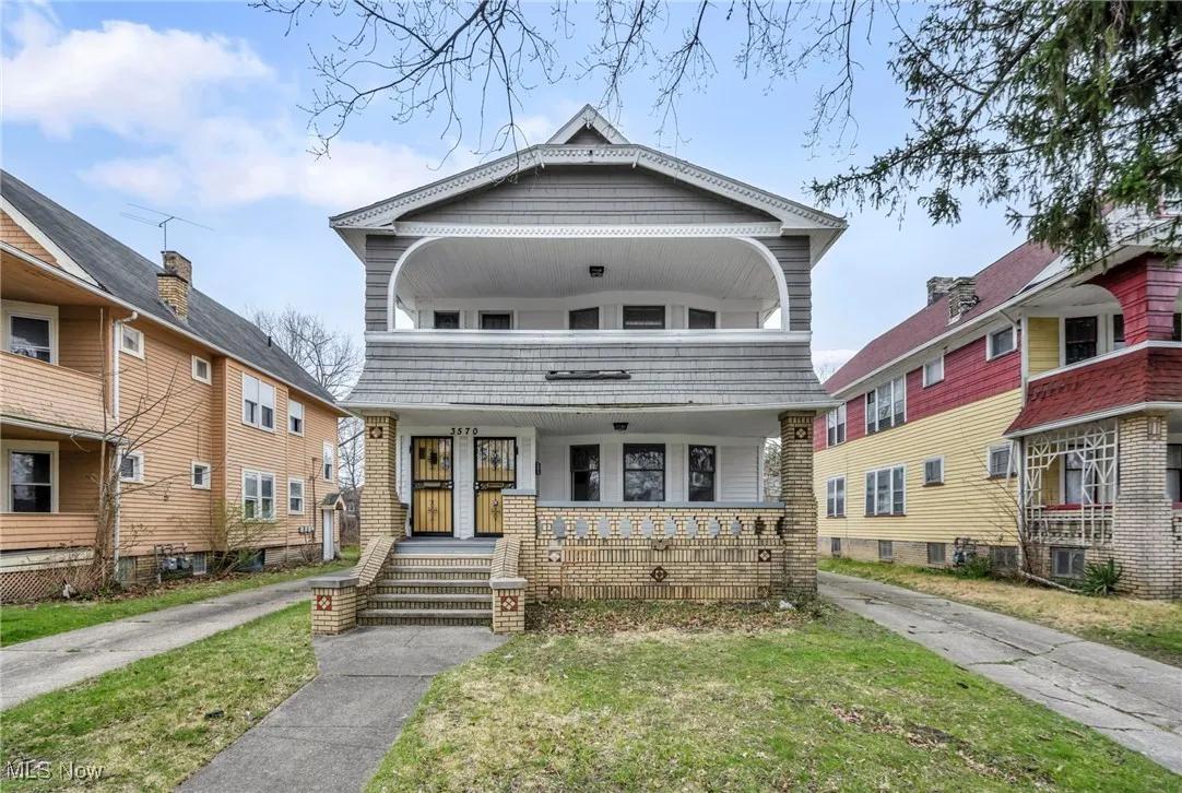 View of front of home with a porch and a front yard
