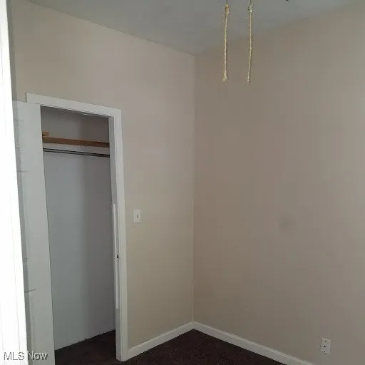 Unfurnished bedroom featuring baseboards