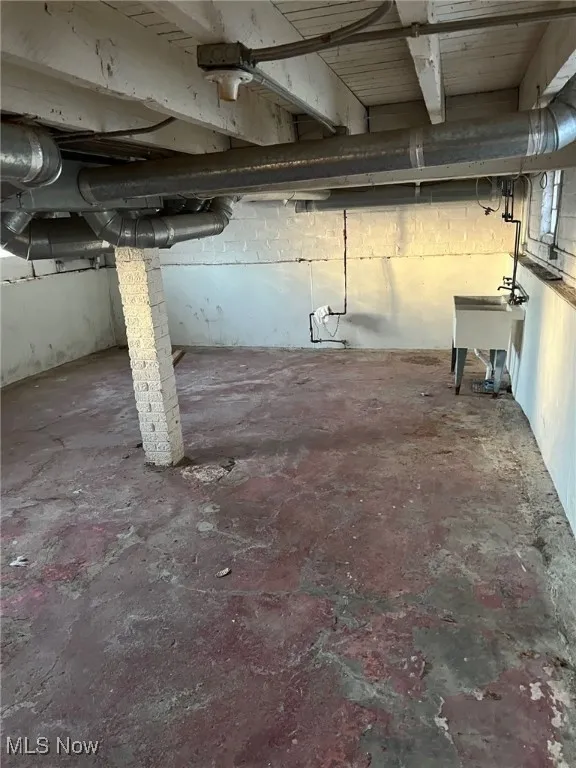 Unfinished basement with a sink