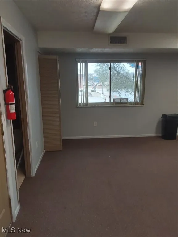 Empty room with visible vents and baseboards