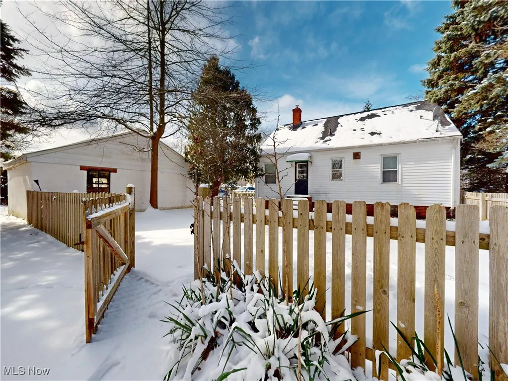Snowy yard with fence