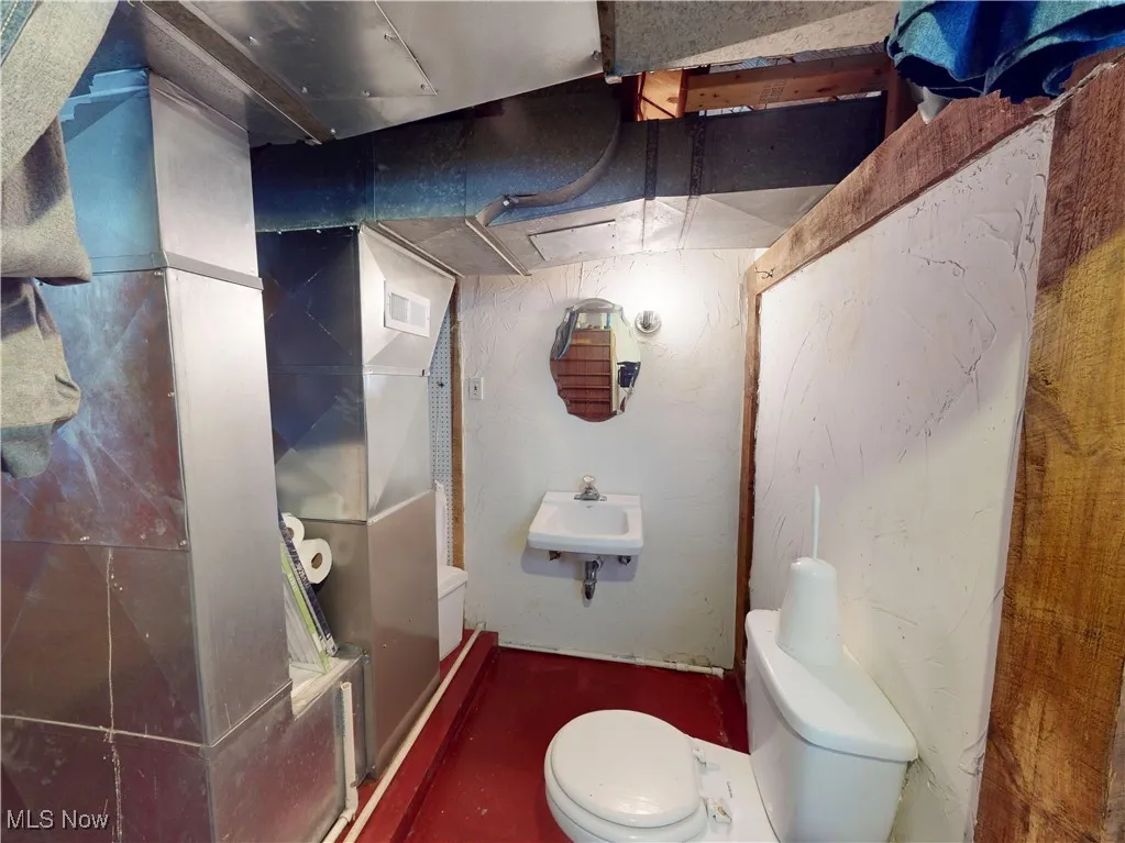 Bathroom with visible vents, a sink, and toilet