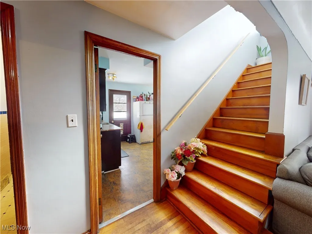 Stairs with arched walkways and wood finished floors