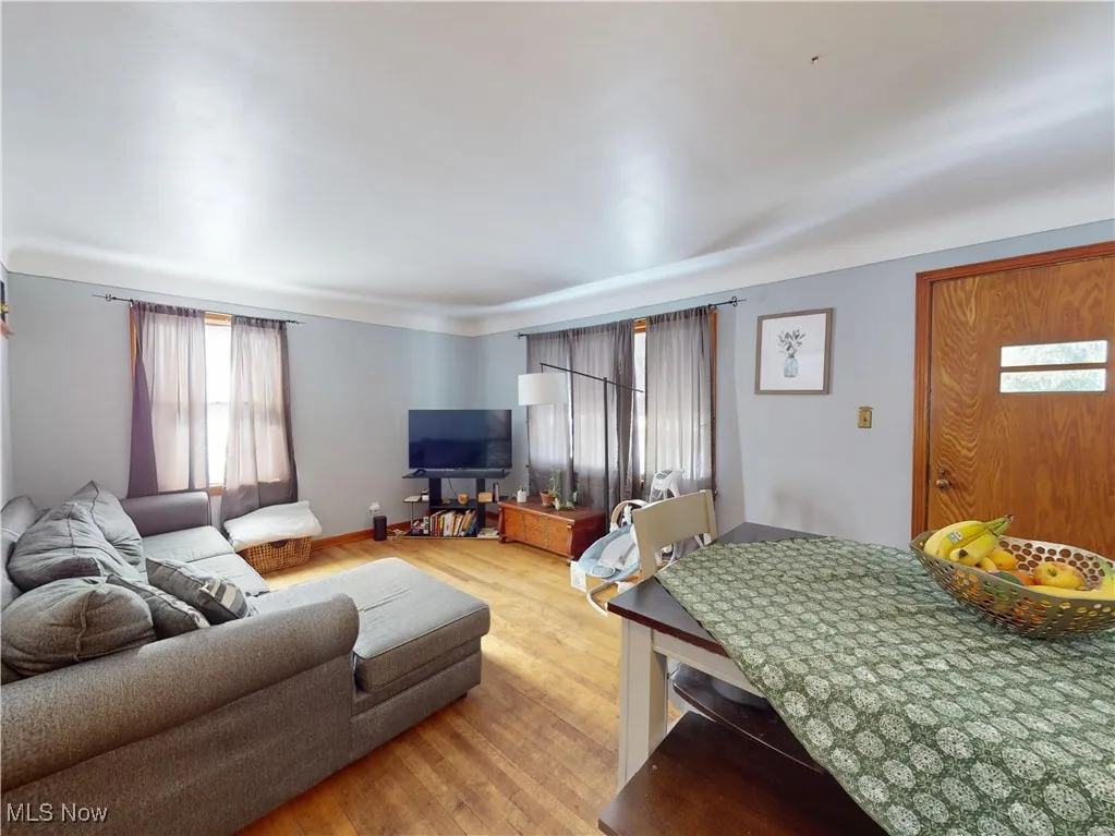 Living room with baseboards and light wood finished floors