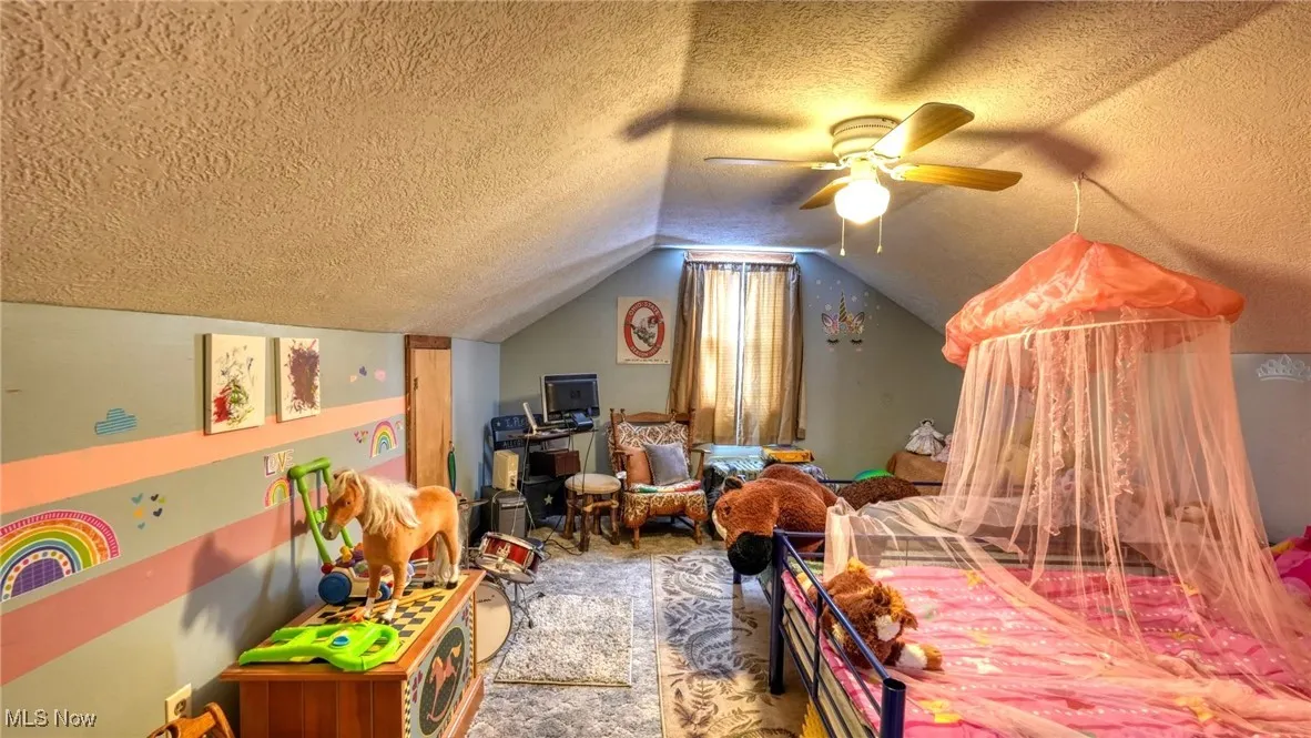 Bedroom featuring ceiling fan and carpet