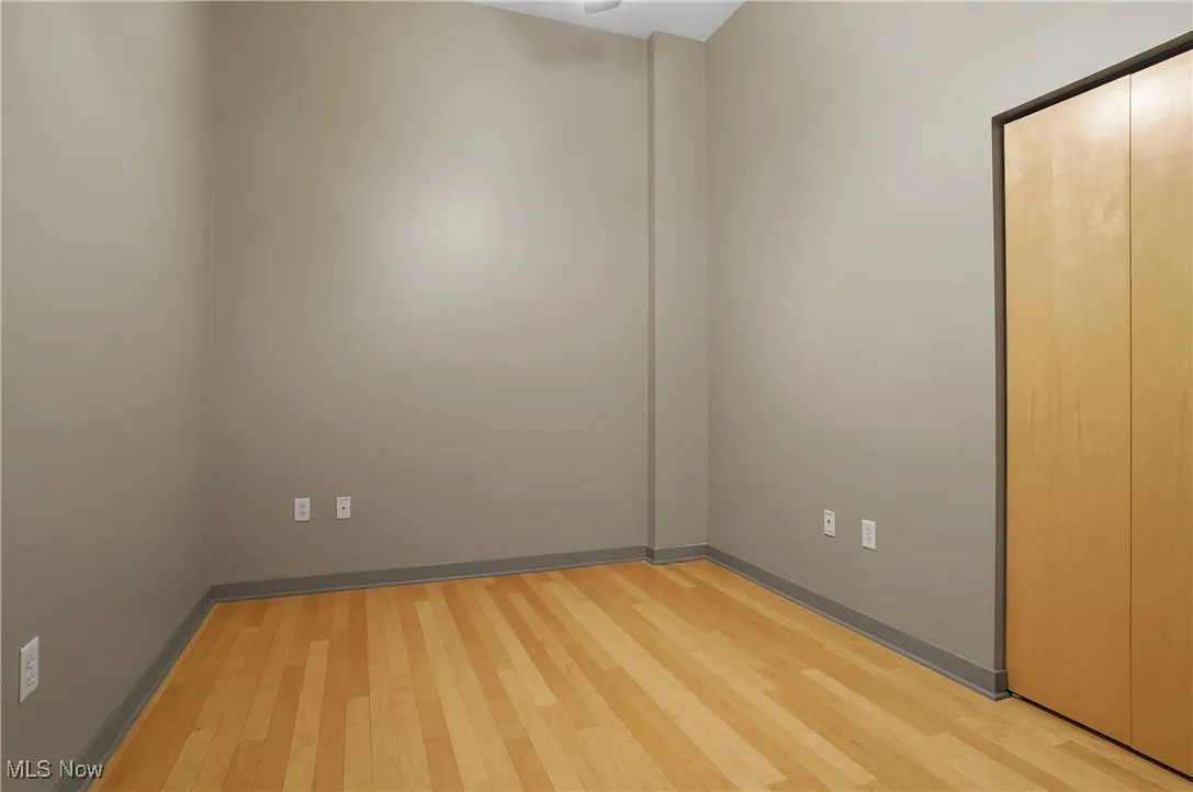 Spare room with light wood-style floors and baseboards