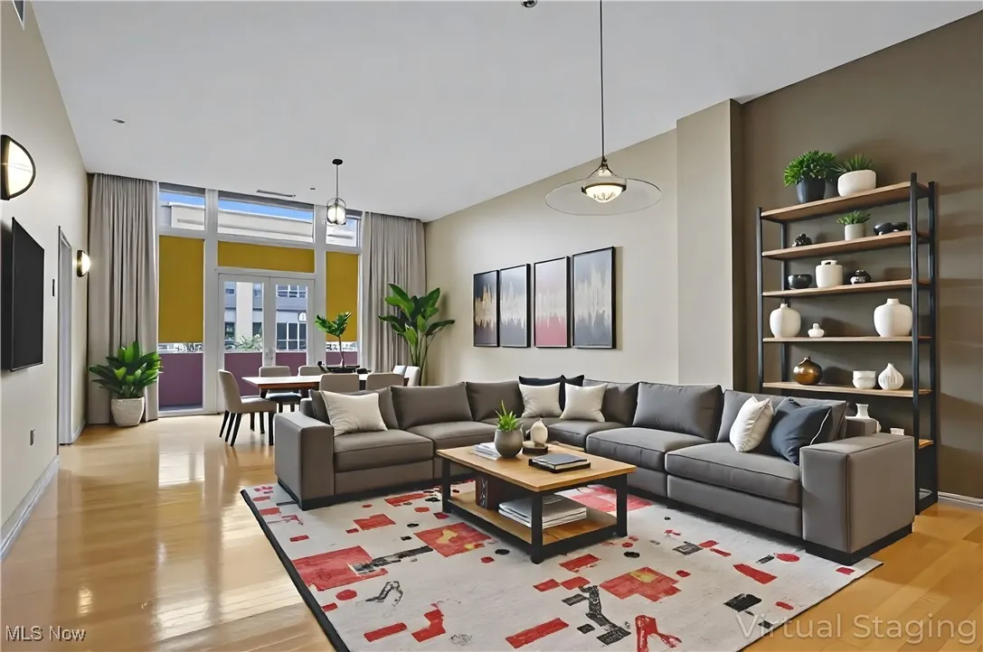 Living area featuring light wood-style floors and floor to ceiling windows