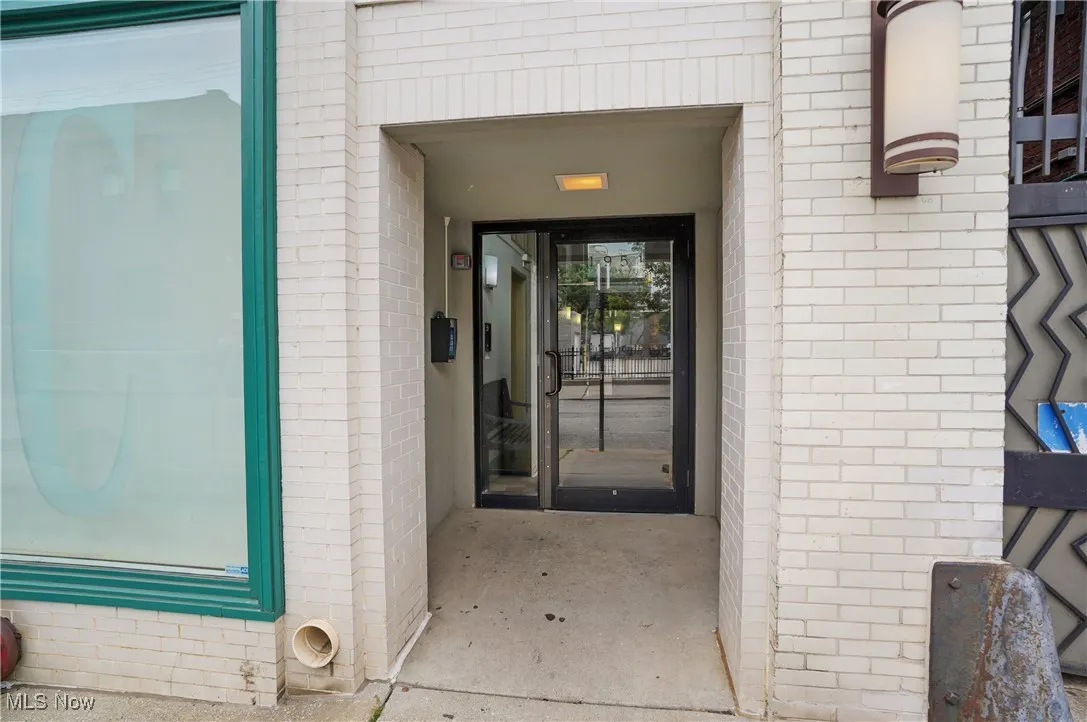 View of exterior entry featuring brick siding