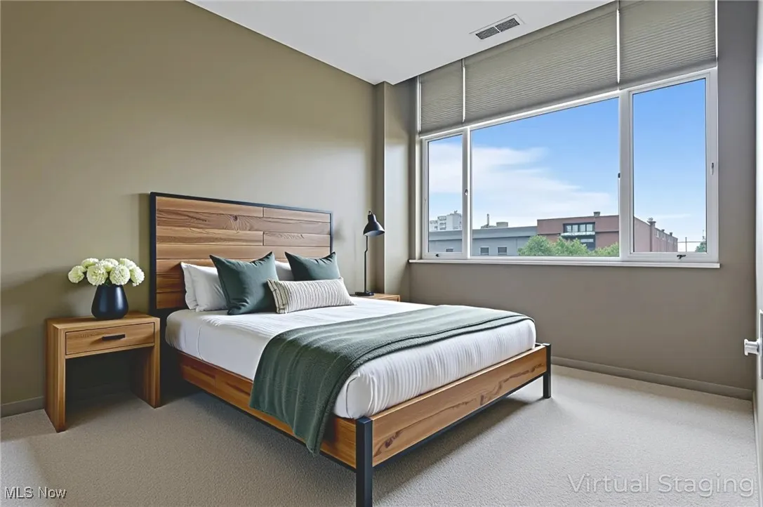 Bedroom featuring multiple windows and carpet flooring
