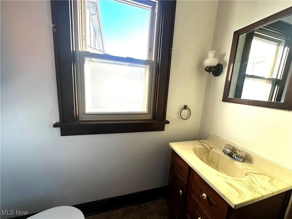 Bathroom with vanity and baseboards