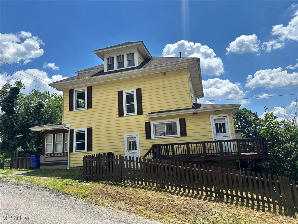 American foursquare style home with a wooden deck
