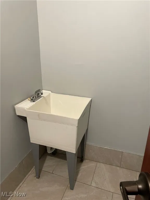 Storage closet featuring tile patterned flooring