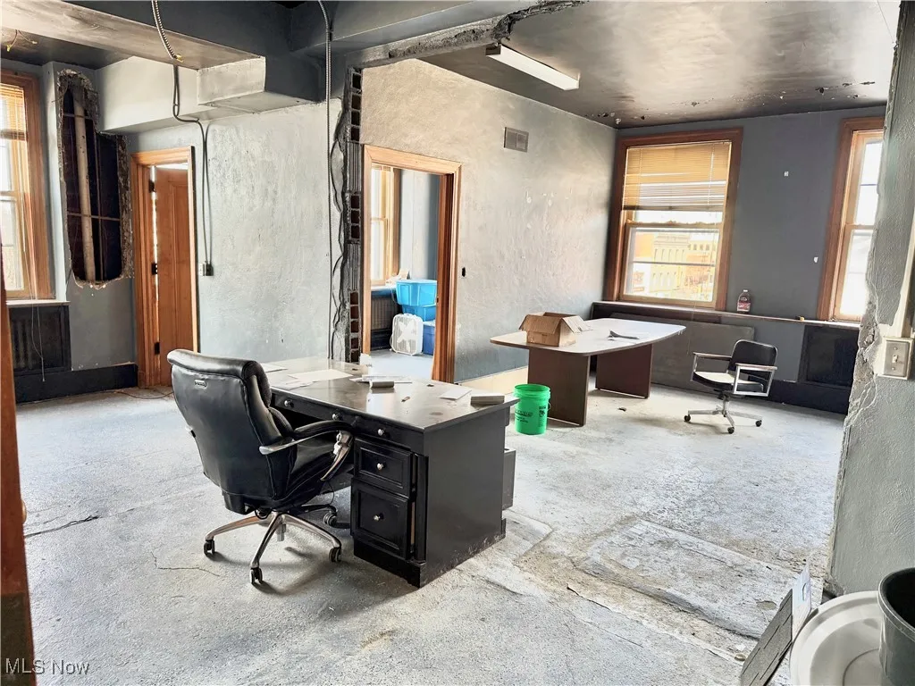 FIRST FLOOR OFFICE SPACE! THERE'S A RECEPTIONS DESK, A PRIVATE OFFICE, AND ROOM FOR A CONFERENCE TABLE.