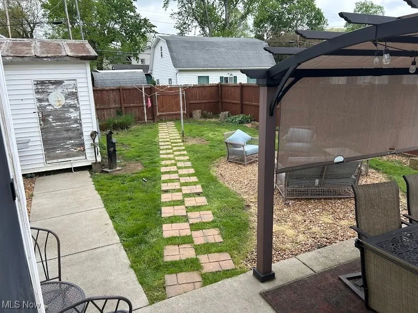 Enclosed back yard with covered pergola/fire pit area
