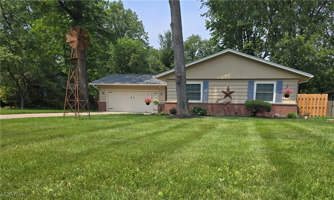 View of front of house with brick siding, a garage, and concrete driveway