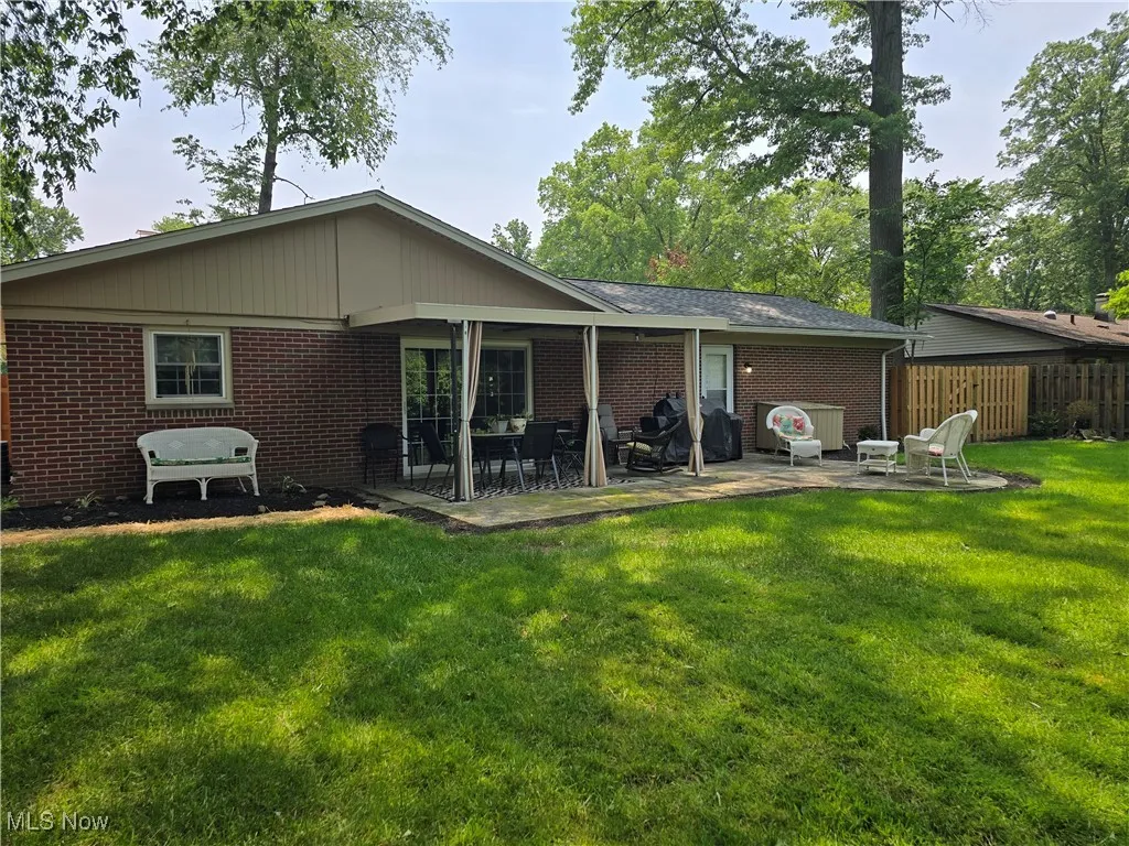 Rear view of property with a patio area and brick siding