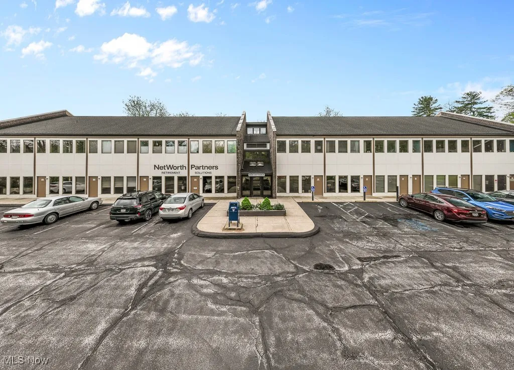 View of commercial location featuring uncovered parking