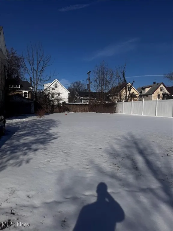 View of yard with a residential view and fence