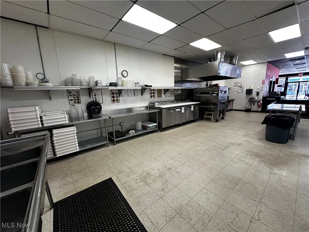 Kitchen featuring a drop ceiling and stainless steel counters