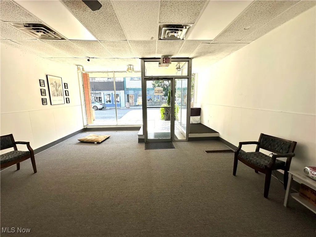 Lobby with floor to ceiling windows and a paneled ceiling