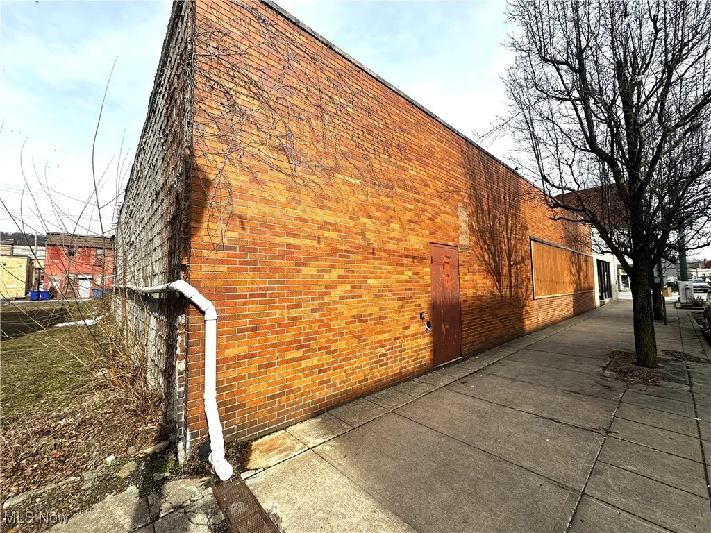 View of side of home with brick siding