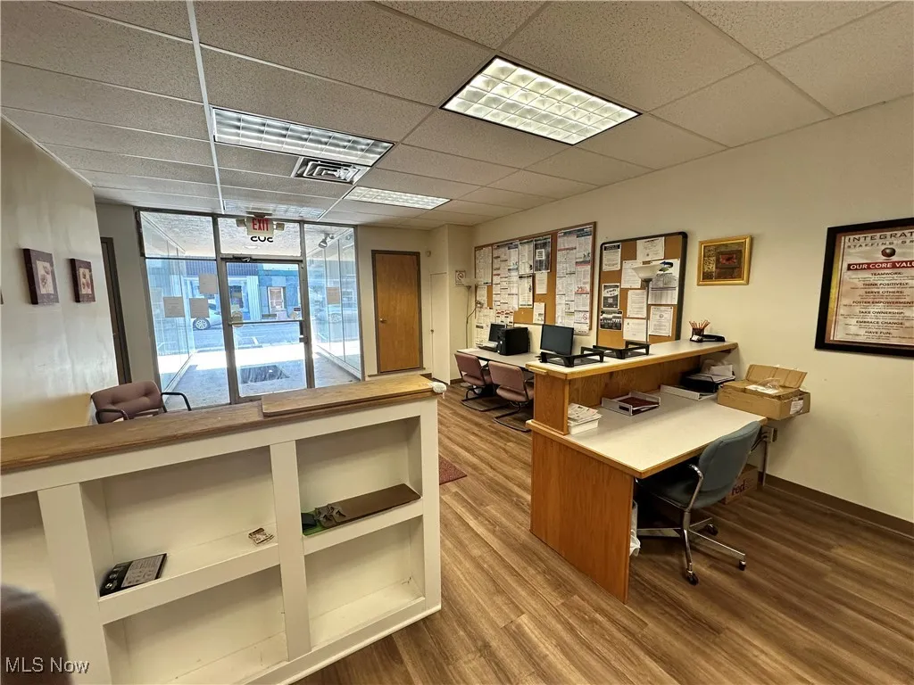 Office area featuring wood finished floors and a paneled ceiling