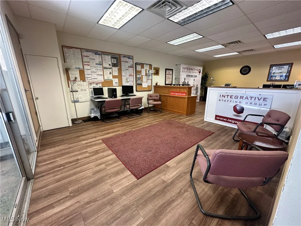 Office space featuring a drop ceiling and wood finished​​‌​​​​‌​​‌‌​‌‌​​​‌‌​‌​‌​‌​​​‌​​ floors