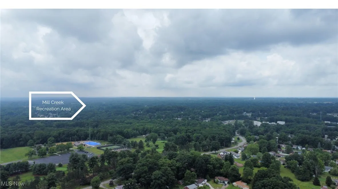 Birds eye view of property with a forest view
