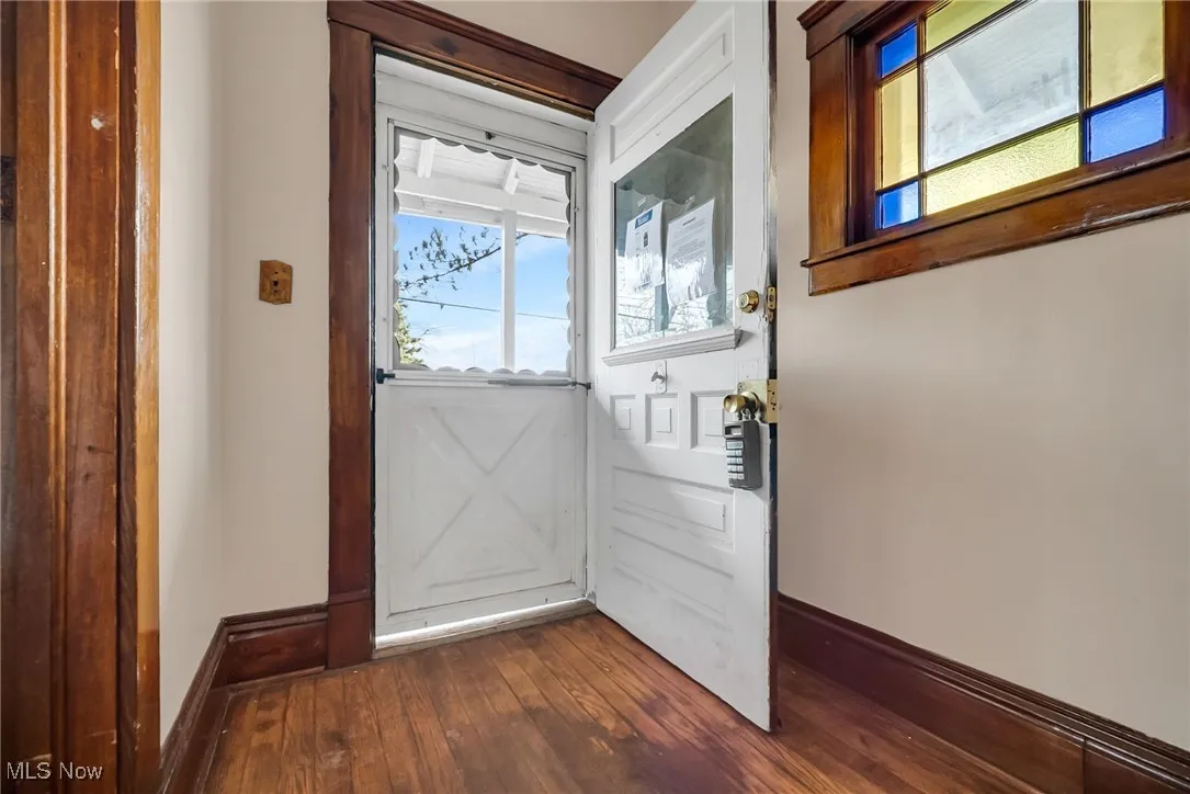 Entryway with dark wood-style floors and baseboards