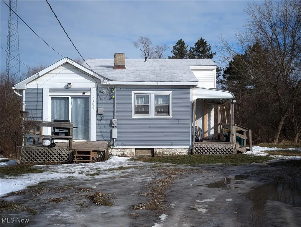 Bungalow-style home with a chimney