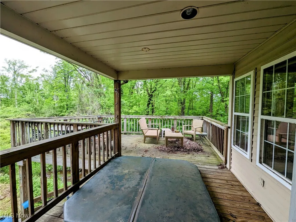 Wooden deck featuring a wooded view