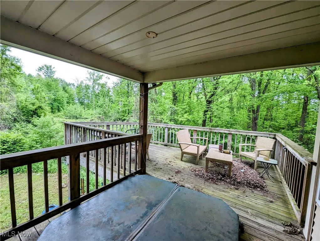 Wooden deck featuring a wooded view