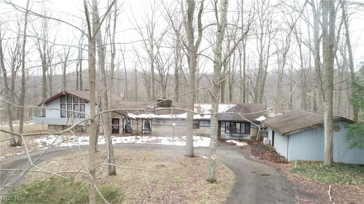 View of front of house featuring aphalt driveway