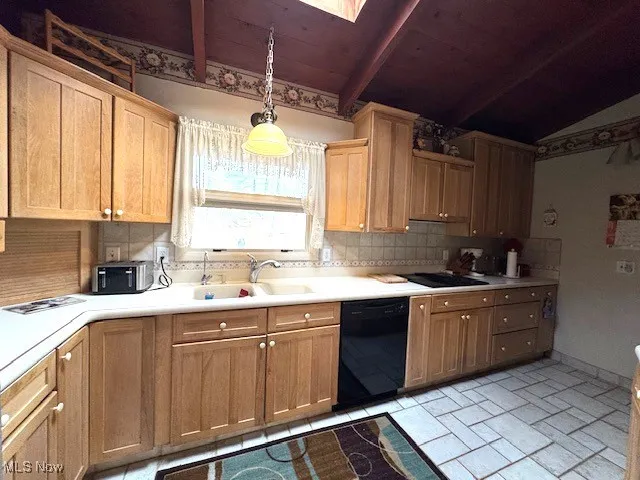 Kitchen with dishwasher, lofted ceiling with beams, decorative light fixtures, light countertops, and a sink