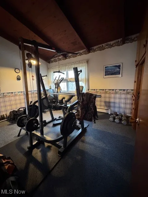 Workout room featuring lofted ceiling and wooden ceiling