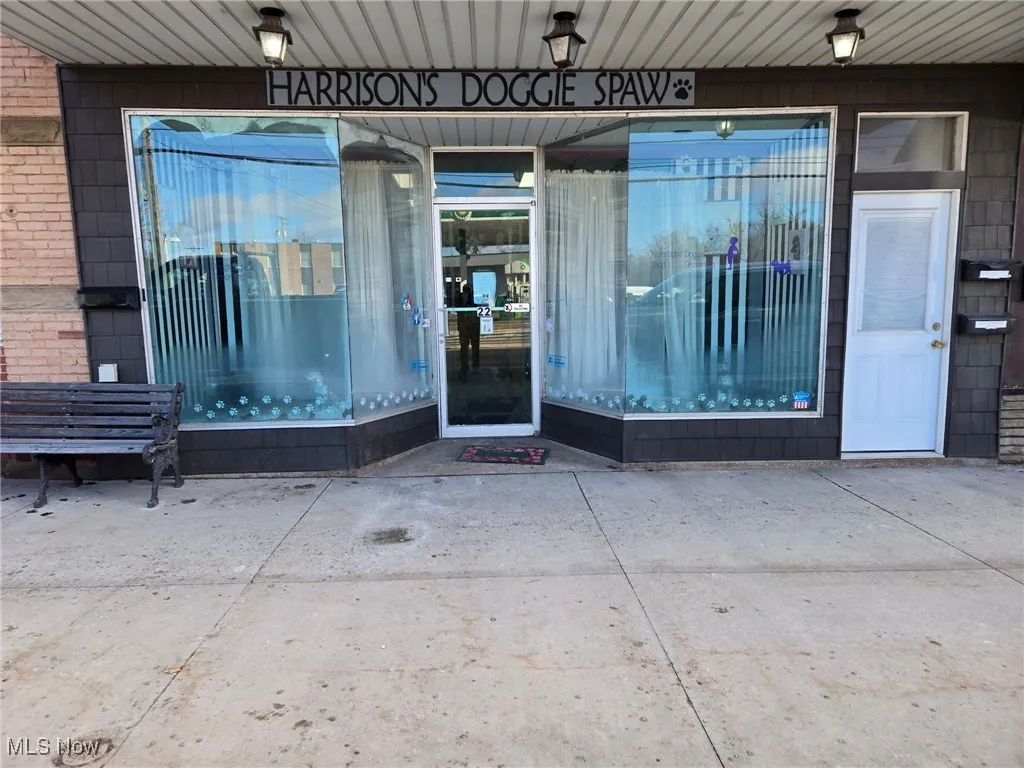 View of exterior entry featuring brick siding