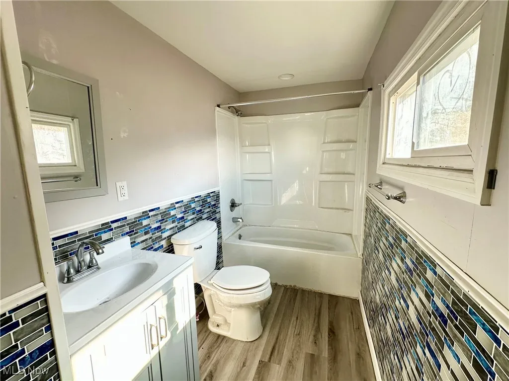 Bathroom with toilet, Shower/bath, and vanity