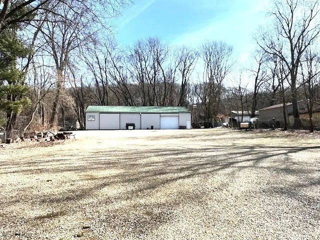View of pole building and gravel parking