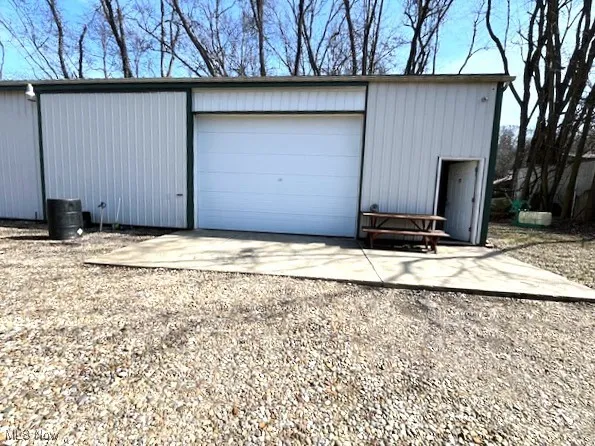 Pole building with concrete pad featuring driveway