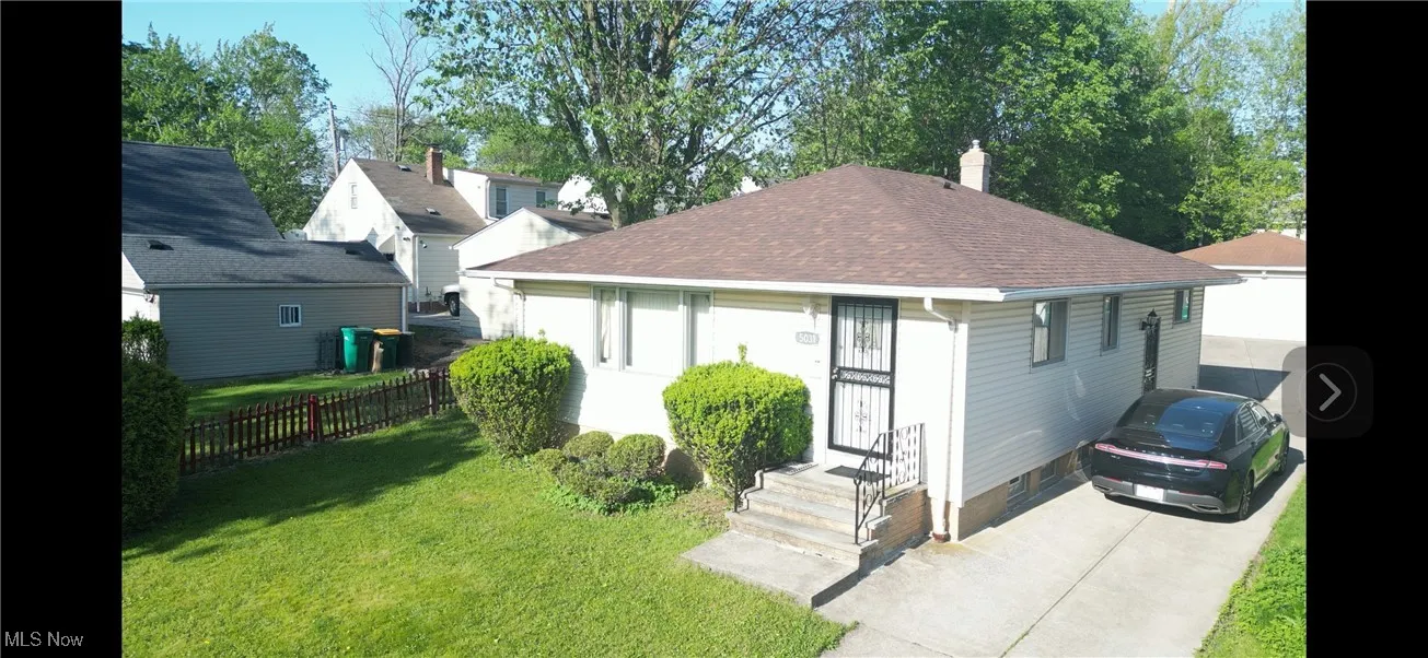 View of front of property featuring a chimney and a shingled roof