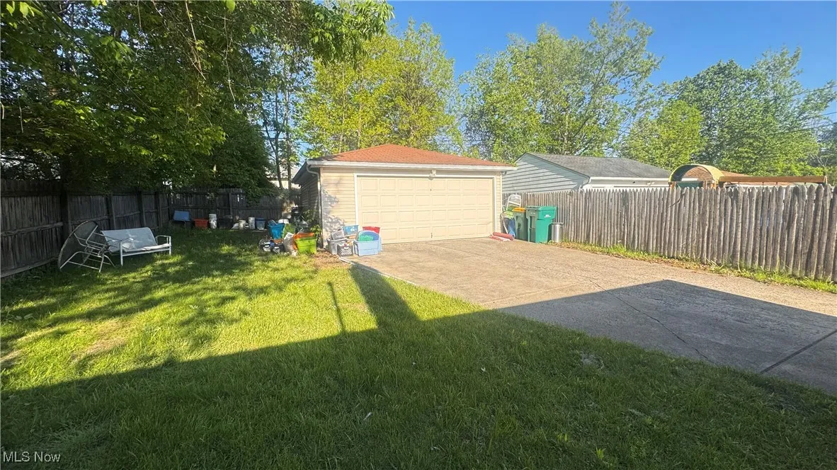 View of yard with a garage and an outdoor structure