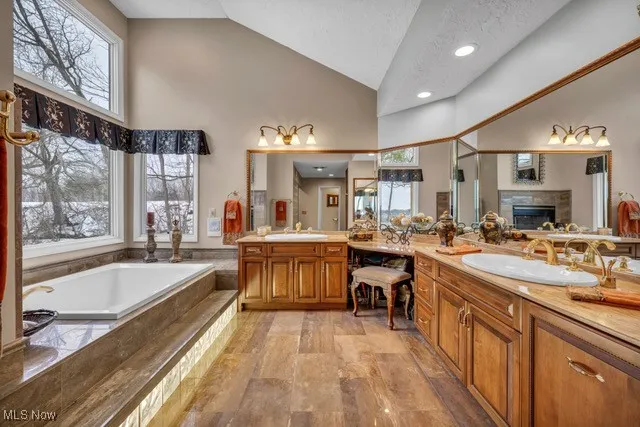 Master bathroom is amazing, custom built cabinets, 24K gold plated faucets, hot and cold filtered water faucet, Wall of windows, fireplace,travertine counters and flooring, added heater under cabinet, heated floor.