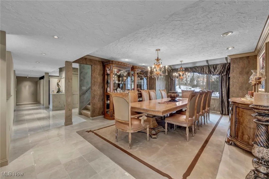 Dining room features two chrystal chandeliers and custom designed carpet insert.