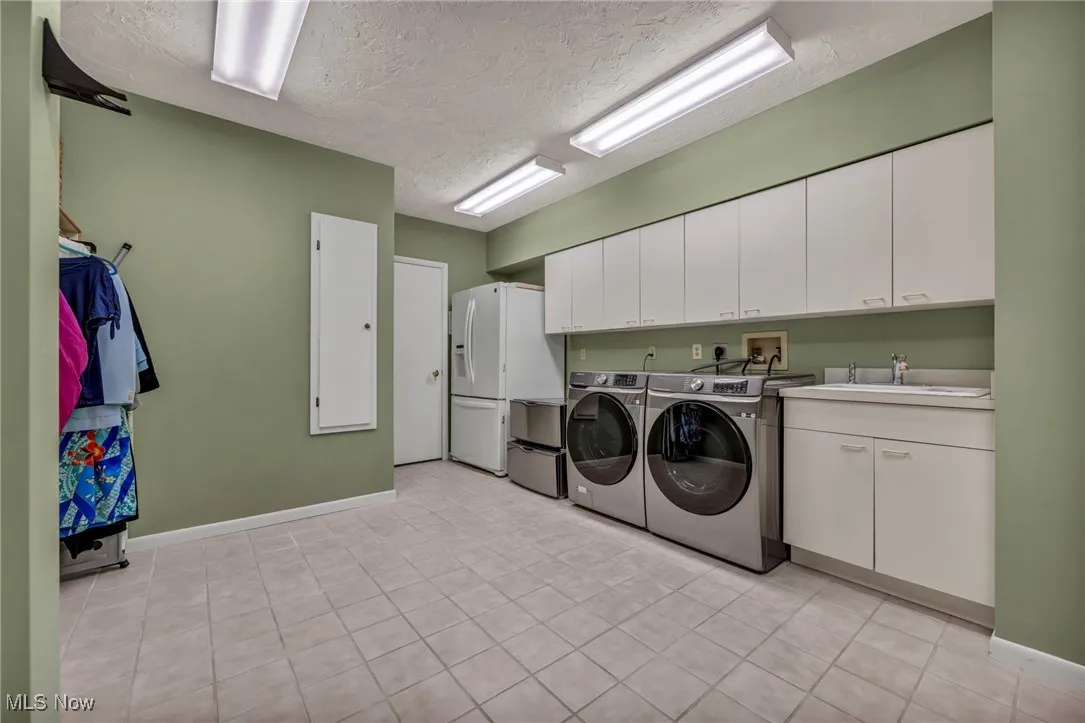 Laundry room with two walls of cabinetry, built in ironing board , clothes shute closet and 8' plus of Hanging area.
Also set up for 2 washers and 2 dryers if needed.