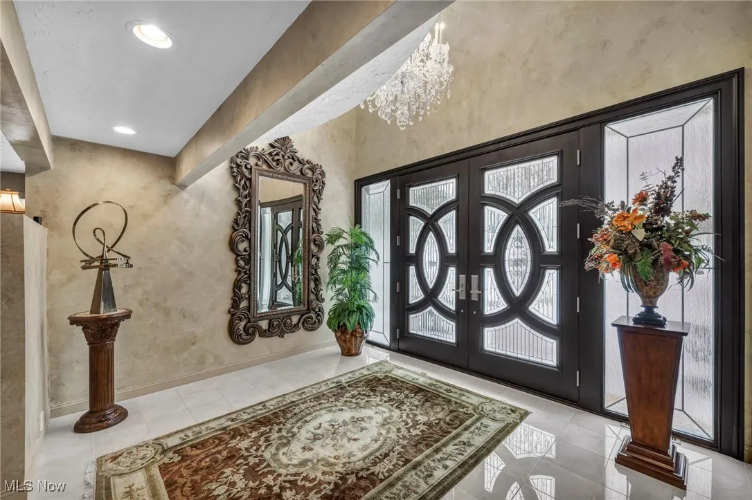 Front Entrance 2 story Foyer Featuring Full Wall of Glass 8' Double Doors and Side Panels.